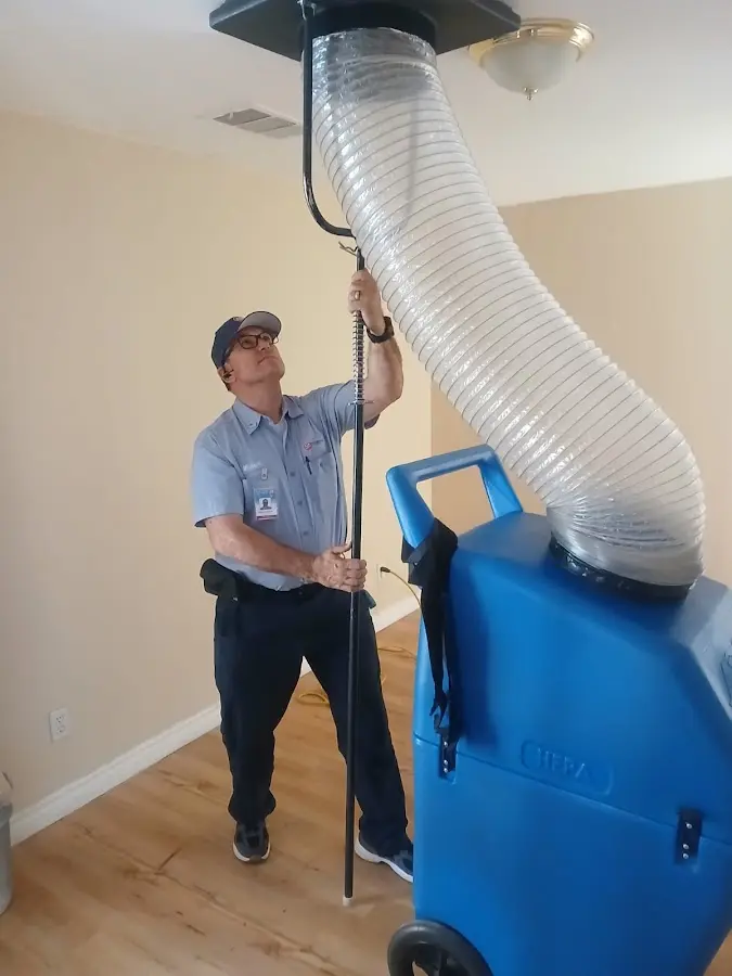 Furnace Tune-Up technician using HEPA equipment in Audubon